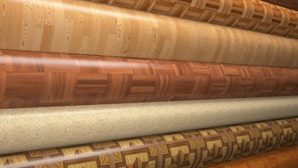 Rolls of retro vinyl flooring in wood, speckled, and geometric patterns illustrate popular 70s' home design trends in practical and decorative surfaces.