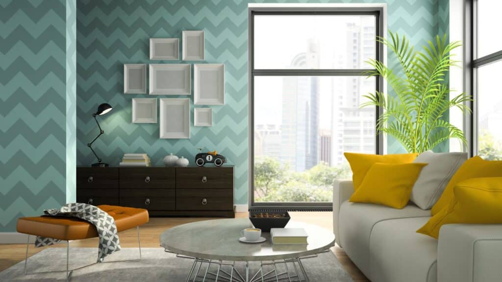 A stylish living room with a teal chevron accent wall, yellow throw pillows, and modern furniture to elevate your home decor.