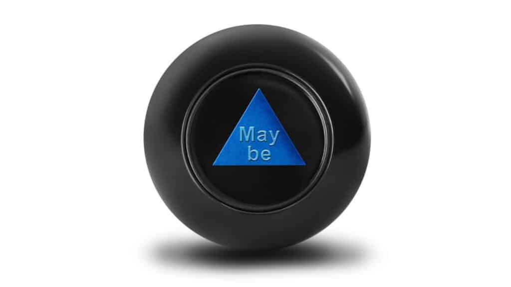A black Magic 8-Ball toy displays the message "Maybe" in a blue triangle. This mysterious fortune-telling toy was a whimsical favorite among childhood toys from the 70s.