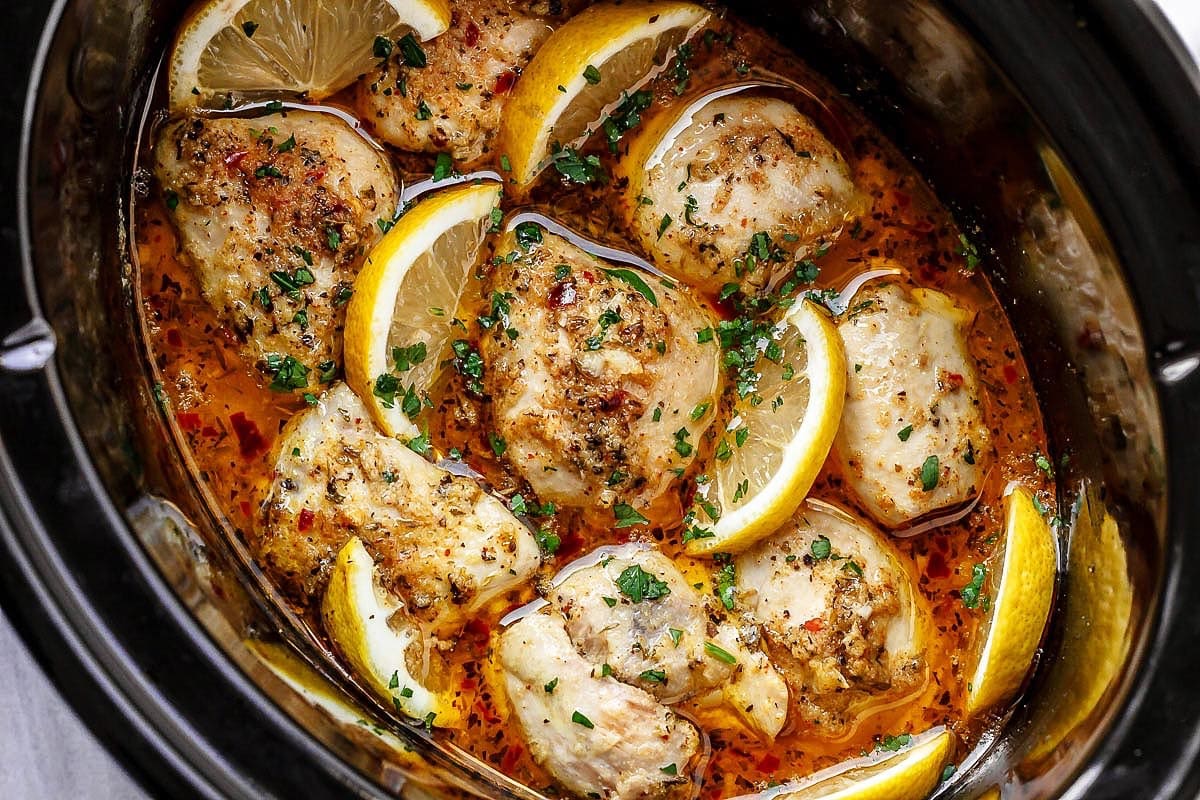 Slow-cooked lemon garlic chicken in a crockpot with herbs and spices, a flavorful and healthy option for easy crockpot recipes.