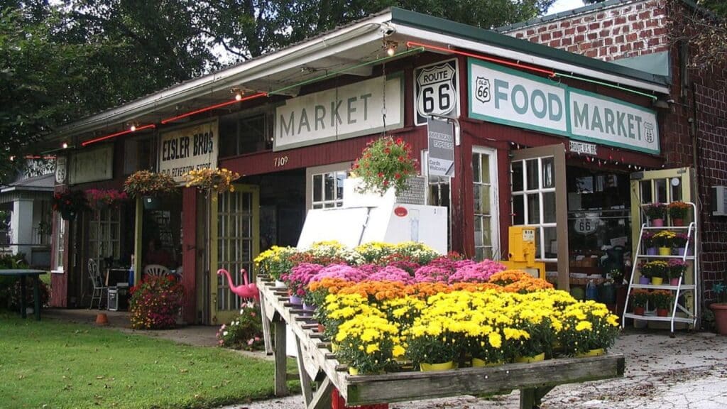 Eisler Bros. Old Riverton Store with a flower stand in front, Route 66 signs, and rustic market signage. A charming hybrid of a market and eatery among restaurants on Route 66.