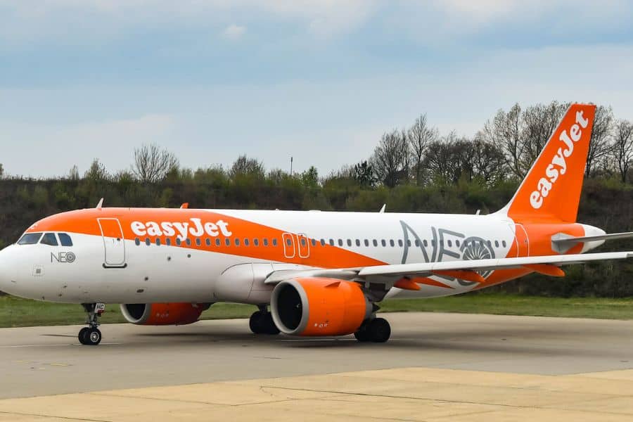 An easyJet airplane parked on the runway, highlighting budget airline travel hacks for saving on flights.