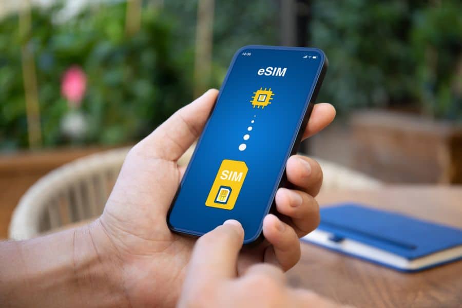 Close-up of a person using an eSIM app on a smartphone, demonstrating tech-savvy travel hacks for staying connected abroad.