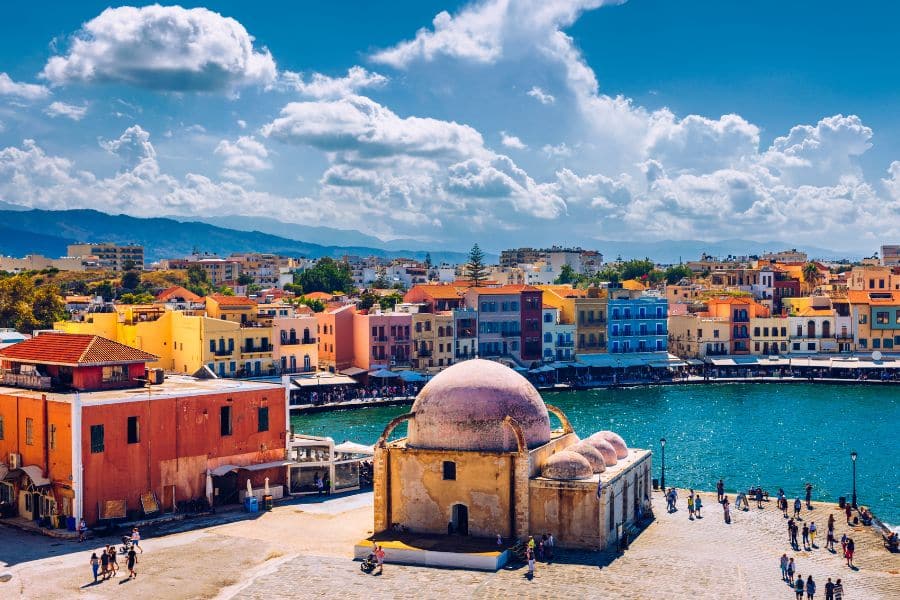 The Venetian harbor in Chania, Crete, featuring colorful buildings and the domed Mosque of the Janissaries. Greece continues to stand out among countries that welcome Americans with its rich culture.