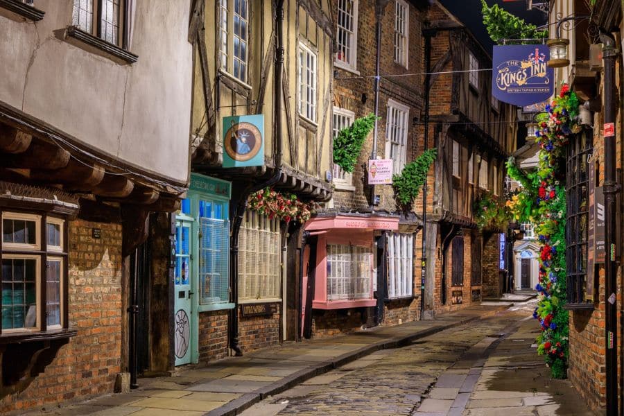 The Shambles in York, England, a narrow medieval street lined with timber-framed shops and inns, is one of the best-preserved Medieval Places to Visit in Europe.