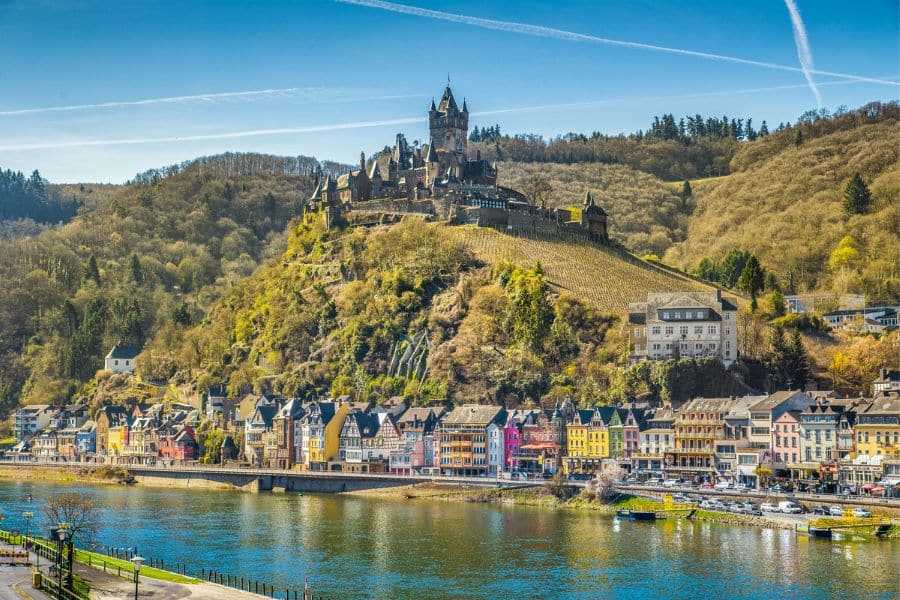 Reichsburg Castle perched above the town of Cochem, Germany, overlooking the Moselle River, is a stunning example of fortified Medieval Places to Visit in Europe.