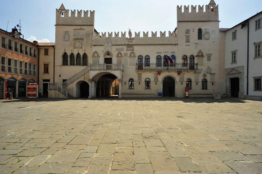 The Gothic-style Praetorian Palace in Koper, Slovenia, with its crenellated roofline and arched windows, is a standout among coastal Medieval Places to Visit in Europe.