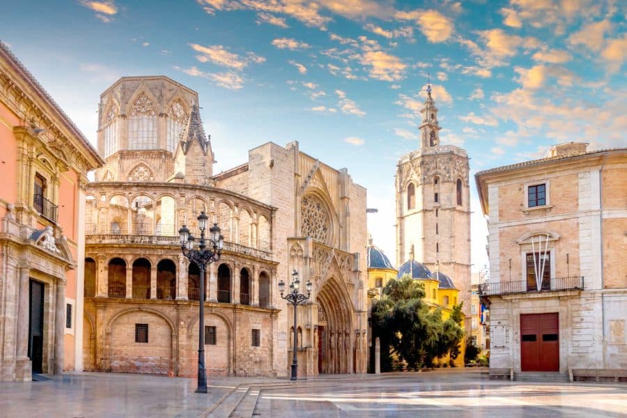 Gothic architecture of Valencia Cathedral in Spain under a colorful sky, highlighting Spain as one of the Cheapest European Countries for budget-conscious tourists.