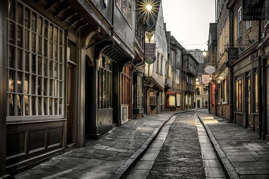A quiet view of The Shambles in York, England, with its timber-framed shops and cobbled path, captures the immersive atmosphere of Medieval Places to Visit in Europe.