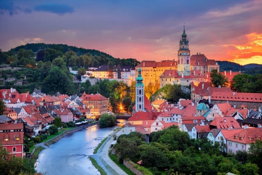 Sunset over Český Krumlov in the Czech Republic, one of the most picturesque small towns in European countries, with its iconic castle and red-roofed buildings lining the Vltava River.