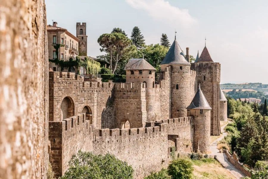 Stone fortifications and towers of Carcassonne, France, basking in sunlight – a must-see among fortified Medieval Towns in Europe.