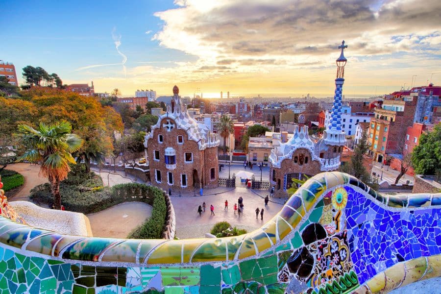 A panoramic view of Park Güell’s whimsical architecture and tiled bench, with Barcelona’s skyline and sea in the distance. Barcelona blends walkable streets and artistic flair, making it a standout among walkable cities in Europe.