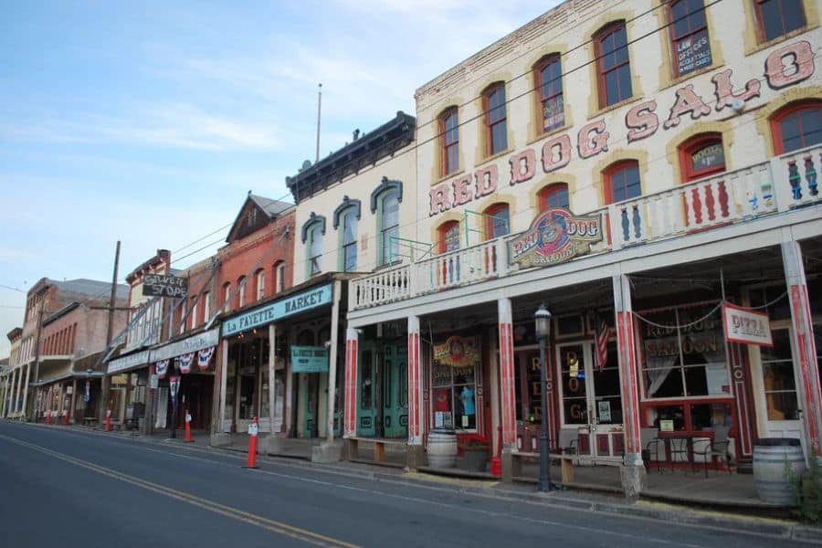 Historic main street with preserved saloons and market buildings lined up along a quiet road in historic American towns.