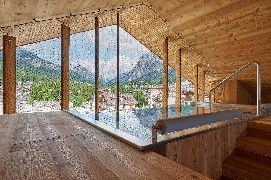 Indoor infinity pool with panoramic mountain views providing luxury accommodation near European National Parks.