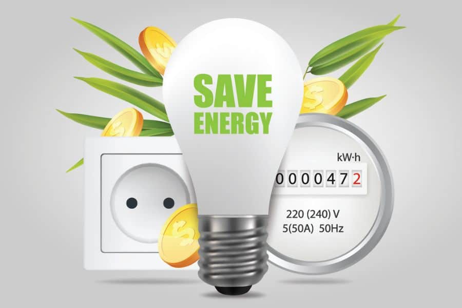 Graphic of a light bulb labeled "SAVE ENERGY" placed in front of an electrical outlet and power meter, with coins and green leaves around it. It highlights energy savings as a way to reduce utility bills during inflation.