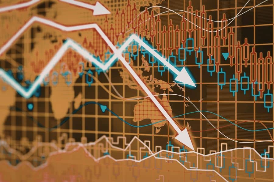 A financial chart overlays a world map with candlestick patterns and several bold arrows pointing downward. It visually represents market declines and volatility, which adds context to discussions about protecting retirement savings during downturns.