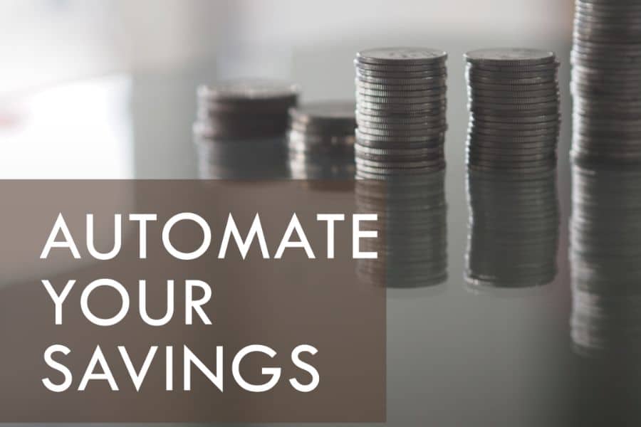 Stacks of coins beside large text reading “AUTOMATE YOUR SAVINGS” on a muted background. The graphic highlights automatic transfers and consistent contributions to help grow an emergency fund over time.