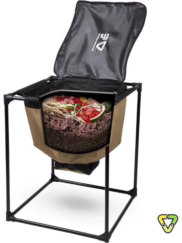 A raised fabric compost bin on a black metal frame with its lid open. A cutaway view shows layers of soil. Worms. Plant trimmings. And food scraps breaking down into compost.